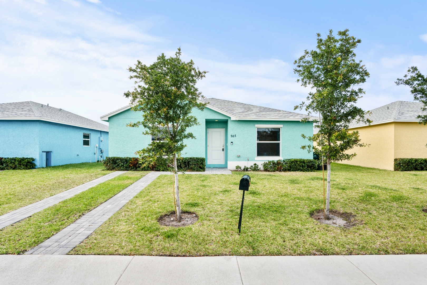 Mint teal Palm Beach villa exterior
